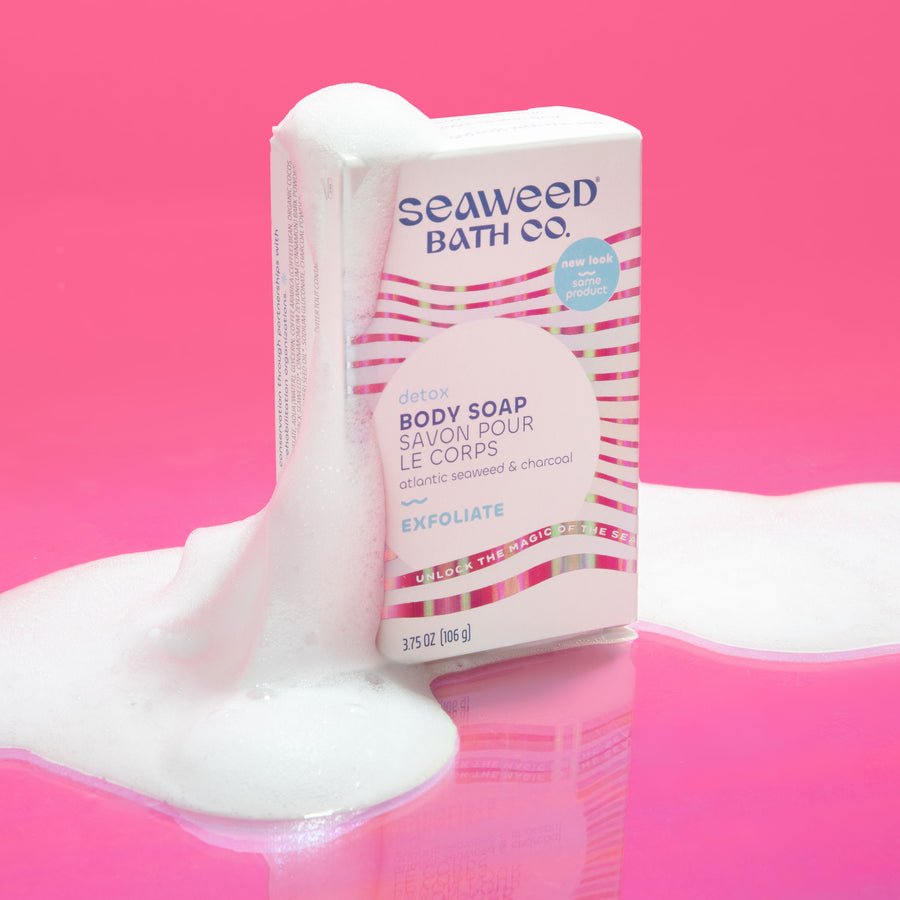 Seaweed Bath Co. Exfoliating Detox Body Soap box on a pink background with soap bubbles.