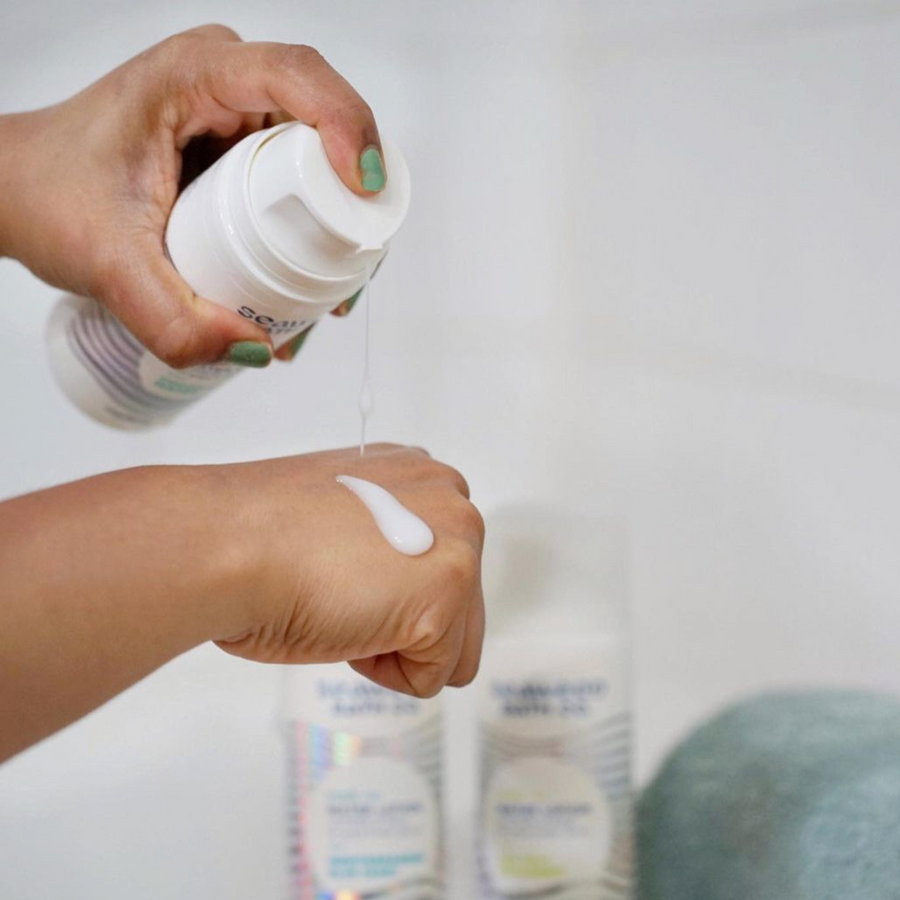 Person applying one pump of Seaweed Bath Co. Melt-In Water Lotion to back of hand to show lightweight consistency of its water-based formula.